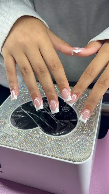 Square nails with a natural pink base and crisp white French tips